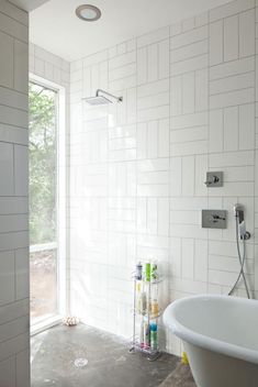 a white bath tub sitting next to a walk in shower