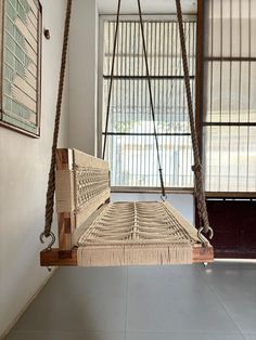 a swing bed hanging from the ceiling in a room