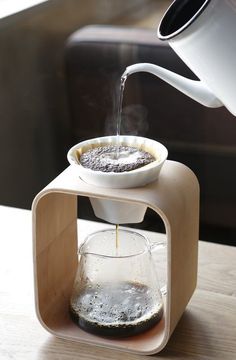 a coffee pot is being filled with water from a pour - o - drip system