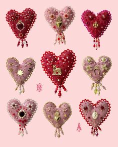 six heart shaped brooches are arranged on a pink background with the letter m