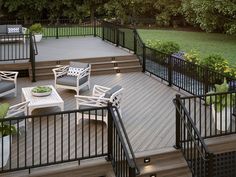 an outdoor deck with chairs and tables on it