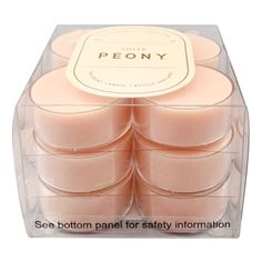 six candles in a clear box with the label peony