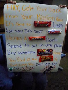 a person holding up a sign with candy on it