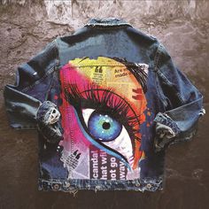 a denim jacket with an eye painted on it