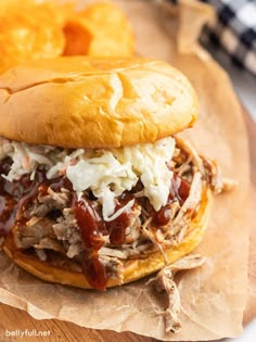 a pulled pork sandwich with cole slaw on top