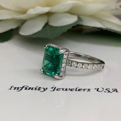 "This ring is an emerald cut lab created emerald with round diamond halo and accents, 14k white gold #5364 We feature the finest quality lab grown emeralds in the world. The properties of lab-grown are physically, chemically and visually identical to natural, just grown in a lab setting. Emerald is the birthstone of May -Approximate total carat weight: 4.05ctw diamond equivalent -Center Stone Size: approx. 3.55ct diamond equivalent -Center Stone Shape: emerald cut 10x8mm -Gem Type: lab created e 14k White Gold Emerald Cut Halo Ring, Gia Certified Emerald Cut Halo Ring, Gia Certified Emerald Cut Cubic Zirconia Halo Ring, Emerald Ring With Diamond Accents Radiant Cut, Gia Certified Emerald Cut Halo Ring As Gift, Emerald Ring With Diamond Accents For Anniversary, Radiant Cut, Radiant Cut Emerald Ring With Diamond Accents For Anniversary, Emerald Ring With Diamond Accents For Anniversary, Emerald Cut Emerald Ring With Halo Setting