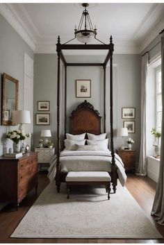 a bedroom with a canopy bed, dressers and two lamps on either side of the bed