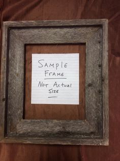 a small wooden frame with a note attached to the bottom that says sample frame not actual size