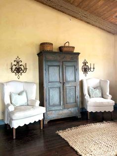 two chairs and a cabinet in a room