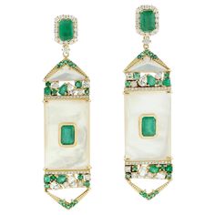 Cast from 14-karat gold, these stunning earrings are hand set with 6.02 carats Emerald, 22.4 carats mother of pearl and 1.52 carats of glimmering diamonds. FOLLOW MEGHNA JEWELS storefront to view the latest collection & exclusive pieces. Meghna Jewels is proudly rated as a Top Seller on 1stDibs with 5 star customer reviews. All items manufactured by us are handmade and can be customized or redesigned. Composition Size-70X17 MM Total Weight-25.861 Gold Weight(Gms)-19.555 Diamond Wt(Cts)-1.52 Emerald Wt(Cts)-6.02 MOP Wt(Cts)-22.4 Luxury Mother Of Pearl Drop Earrings, Luxury Formal Pearl Earrings With Mother Of Pearl, Luxury Mother Of Pearl Earrings For Formal Occasions, Luxury Pearl Earrings With Diamond Accents, Silver Things, Earrings Emerald, Bling Earrings, 18k Gold Earrings, Gold Dangle Earrings