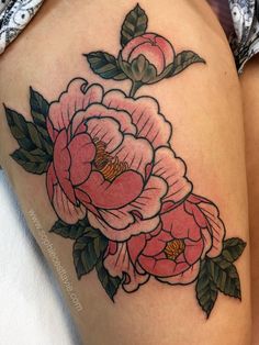 a woman's thigh with pink flowers on the side and green leaves around it