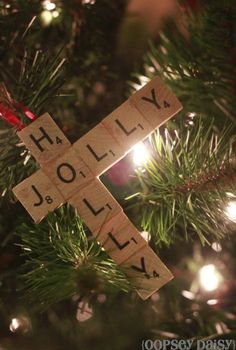 a wooden cross ornament hanging from a christmas tree