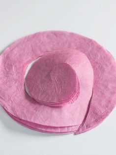 a pink hat sitting on top of a white table