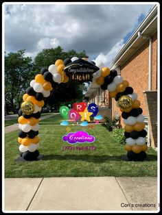 the balloon arch is decorated with black, white and gold balloons that spell out congratulations