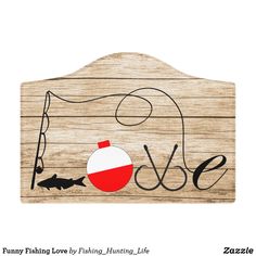 a wooden sign with the word love and fish on it, hanging from a hook