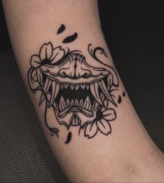 a close up of a person's foot with a tattoo design on the leg