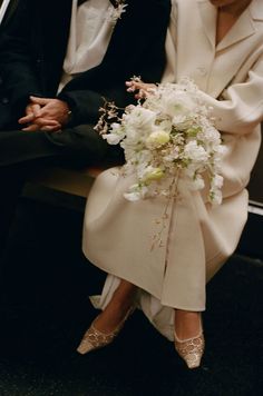 a bride and groom sitting next to each other