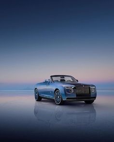 the new rolls royce roadster convertible is shown in front of an ocean view at dusk