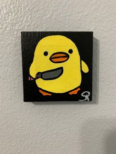 a painting of a yellow duck with a knife in it's mouth on a white wall