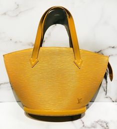 Louis Vuitton Saint Jacques Epi yellow bag in very good condition, with slight wear on the bottom of the bag and one mark on the lining (please see pictures). Approximate Measurements: Size PM, Length 9”, Height 8.5”, Handle Drop 5.5”Made in France. Formal Yellow Bag With Double Handle, Formal Yellow Shoulder Bag With Double Handle, Formal Yellow Double Handle Bag, Formal Yellow Double Handle Bags, Classic Yellow Formal Bag, Formal Yellow Shoulder Bag With Top Carry Handle, Yellow Business Satchel Bag, Luxury Yellow Business Bags, Yellow Business Bags With Gold-tone Hardware