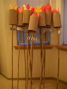 a bunch of sticks that are sitting in front of a window with flowers on them