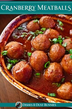 cranberry meatballs are served in a dish with green onions and garnishes