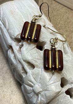 I Designed these from a firepolished rectangular Glass bead.Rich dark Topaz with golden accents. The Ear wire is a hypoallergenic Gold fishhook. Great for those  sensitive ears. Beautiful Bead! Brown Rectangular Earrings With Ear Wire, Handmade Elegant Rectangular Beaded Earrings, Elegant Handmade Rectangular Beaded Earrings, Elegant Handmade Beaded Rectangular Earrings, Elegant Rectangular Czech Glass Jewelry, Rectangular Earrings, Sensitive Ears, Ear Wire, Glass Bead