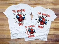 two white shirts with spiderman and the amazing dad printed on them, sitting next to each other