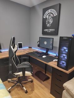 a computer desk with two monitors and a keyboard on top of it in a room