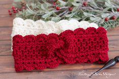 a crocheted red and white headband sitting on top of a wooden table