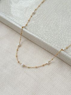 "A Pearl station necklace is a jewelry box staple you will adore for years to come! Each genuine Pearl is hand wrapped in your choice of sensitive skin safe 14K Gold Filled or 925 Sterling Silver. The dainty yet durable beaded chain adds a hint or shimmer to the design.  This versatile chain makes a lovely gift, or a stunning wedding necklace! Pair it with the station Pearl bracelet for a gorgeous matching set. * Choose your length (with adjustable 2\" extender chain) * 15\"+2\" extender or 18\" Pearl Necklace Freshwater, Dainty Pearl Necklace, Pearl Chain Necklace, Women Bride, Pearl Necklace Wedding, Basic Jewelry, Pearl Choker Necklace, Necklace Wedding, Freshwater Pearl Necklace