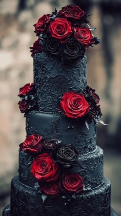 a black and red wedding cake with roses on it