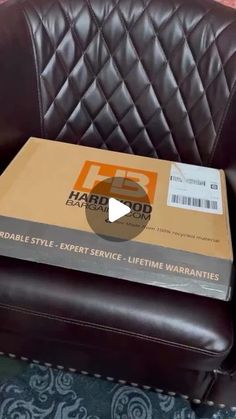 a brown leather chair with a box on it