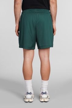 Shorts in green polyester, elasticated waistband, coulisse closure, perfored, side logo print, Made in Cambodia, Model is 1. 83 and wears size M Sporty Green Gym Bottoms, Green Moisture-wicking Sportswear Bottoms, Green Drawstring Bottoms For Streetwear, Green Go-dry Sportswear Bottoms, Green Go-dry Sports Bottoms, Green Nylon Bottoms With Elastic Waistband, Green Sports Shorts With Elastic Waistband, Green Nylon Athletic Shorts For Sports, Green Athletic Shorts With Built-in Shorts For Sports