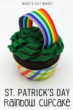 there is a cupcake with green icing and a rainbow decoration on top that says st patrick's day rainbow cupcake