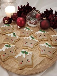 decorated cookies are arranged on a wooden platter