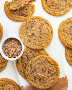 chocolate chip cookies are arranged on a cutting board