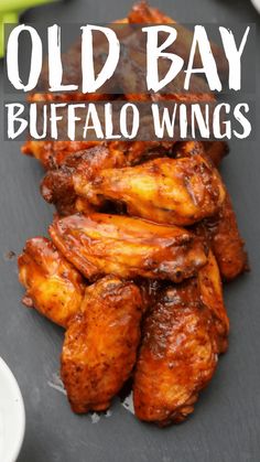 an old bay buffalo wings recipe on a black plate with text overlay that reads, old bay buffalo wings