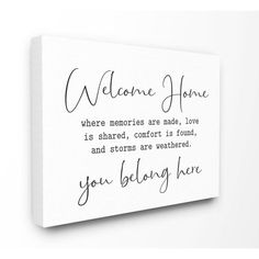 a white canvas with the words welcome home and you belong here written on it in black ink