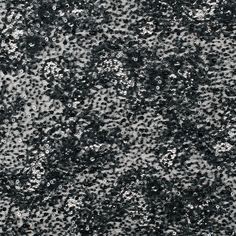 black and white abstract textured background with lots of small dots in the middle,