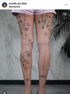 a woman's legs with flowers and vines tattooed on the back of her leg