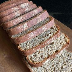 a loaf of bread sitting on top of a wooden cutting board