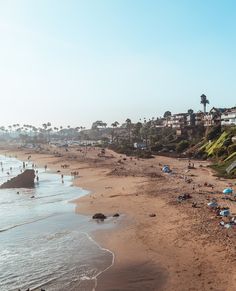 the beach is crowded with people and umbrellas on a sunny day in la jolla, california