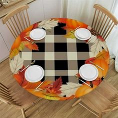 an image of a table setting with plates and place settings on the plate cover in autumn leaves