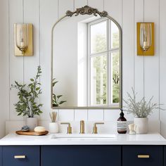 a bathroom with a large mirror and blue cabinets