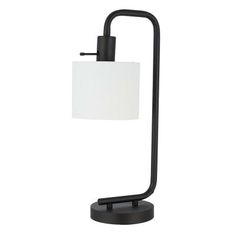 a black table lamp with a white shade on the top and an iron frame base