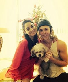 two women and a dog pose for a photo