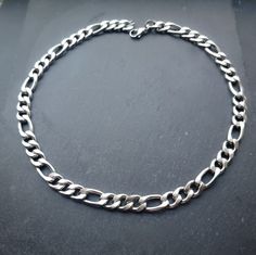 Super chunky figaro/curb chain necklace in silver! Unisex. This necklace is made of high quality stainless steel so is water resistant and won't tarnish or discolour! Available in various sizes. Mens necklace shown in photographs measures 22 inches Womens necklace shown in photographs measures 17 inches. Please don't hesitate to contact me with any queries or suggestions 😊  Comes gift wrapped 💜 Silver Stainless Steel Necklace With Figaro Chain, Silver Stainless Steel Figaro Chain Necklace, Modern Stainless Steel Figaro Chain Necklace, Stainless Steel Cuban Link Necklace With Figaro Chain, Stainless Steel Figaro Chain Necklace, Figaro Chain Necklace, Mens Necklace, Curb Chain Necklace, Figaro Chains