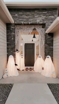 halloween decorations are on display in front of a home's entryway, decorated for the holiday season