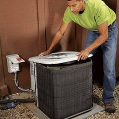 a man fixing an air conditioner outside